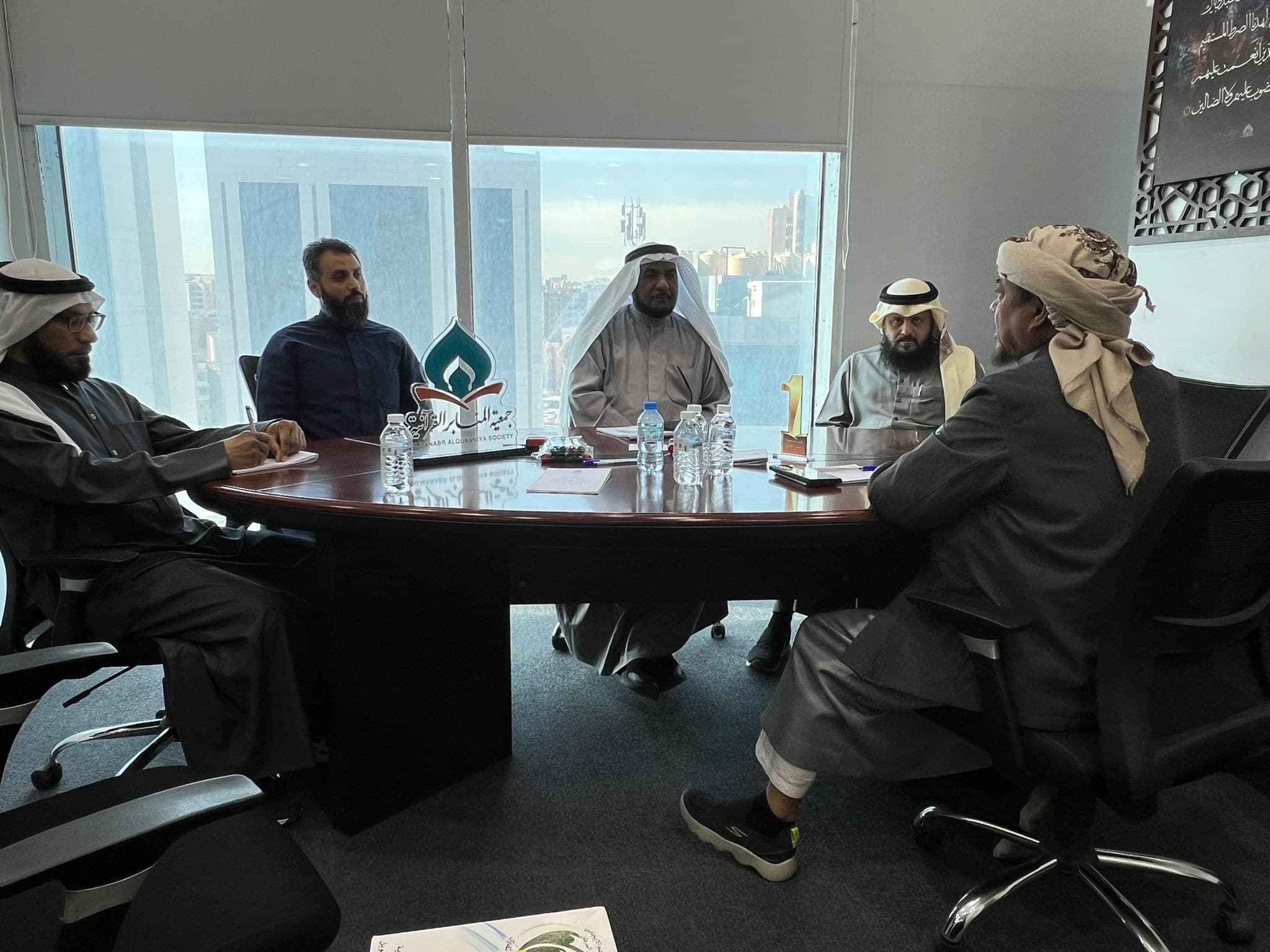 Dr. Noor Mohammed Badie in an institutional boardroom meeting.